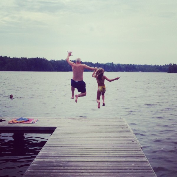 Kate and Bob Borson jumping off a dock